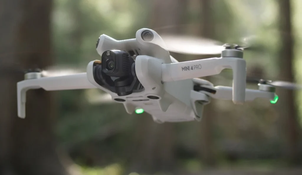 Imagen de un DJI Mini 4 y de fondo un bosque