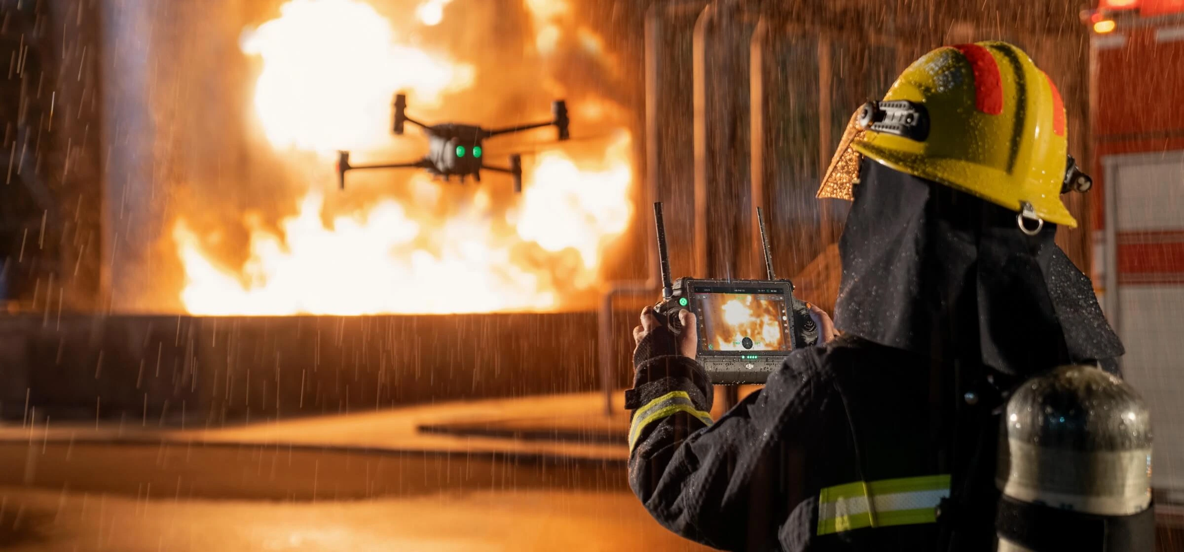 Primero plano, un bombero piloteando un dron en medio de la lluvia, segundo plano un incendio 